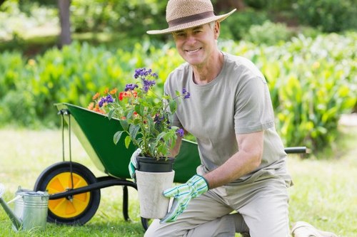 Garden maintenance tools and neat beds near terraced houses