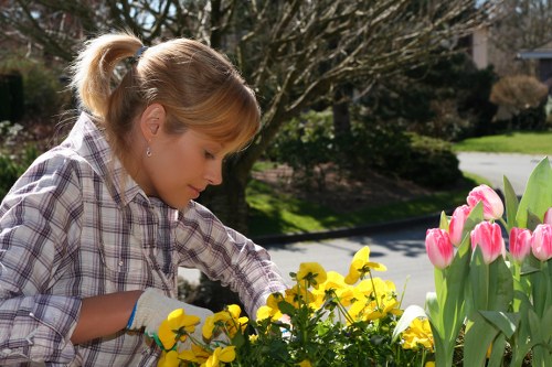 Gardener wearing protective clothing operating machinery